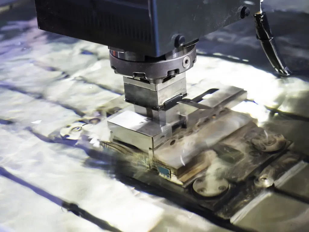 Nahaufnahme einer Funkenerosionsmaschine (EDM), die in Flüssigkeit getauchtes Metall schneidet und den Präzisionsbearbeitungsprozess veranschaulicht.